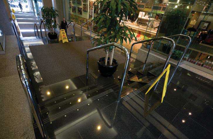 An example of poor stair design – black stairs with no colour contrast on the nosing.