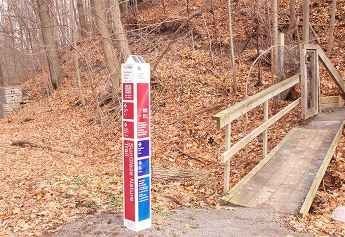 A photo of trail identification signage that incorporates large-print, tactile and audible information. Source: Tour-Mate Systems Limited.